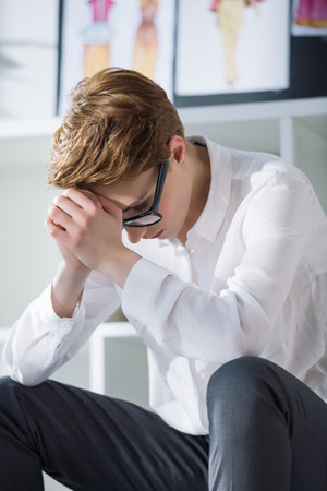 close-up portrait of thoughtful stylish fashion designerの写真素材
