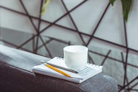close-up view of notebook, pencils and cup of coffeeの写真素材