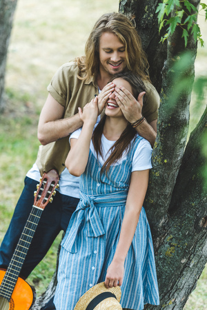 happy young couple with guitar in parkの写真素材