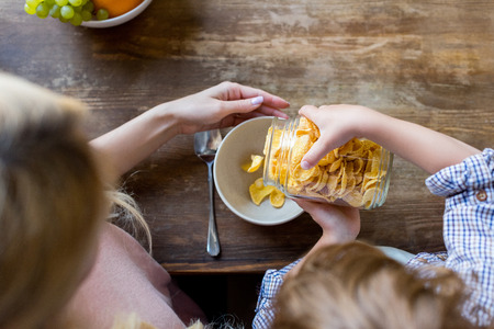 overhead view of mother and son preparing corn flakes for breakfast の写真素材