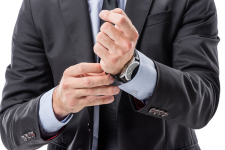 cropped shot of businessman in formal wear buttoning watchの写真素材