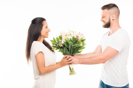 'portrait of handsome bearded man standing with bouquet of flowers, isolated on whiteの写真素材