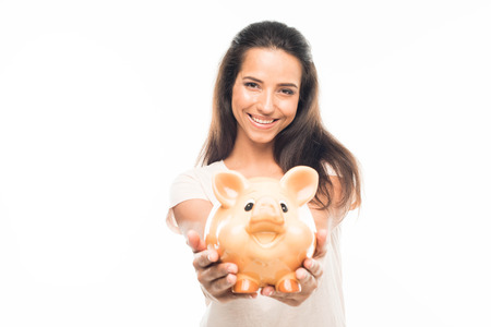 'Portrait of attractive woman with piggy bank, isolated on whiteの写真素材