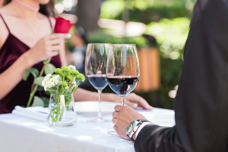 Couple during romantic date, sitting at table in restaurant with wineの写真素材