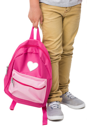 cropped shot of schoolboy holding pink backpack isolated on whiteの写真素材