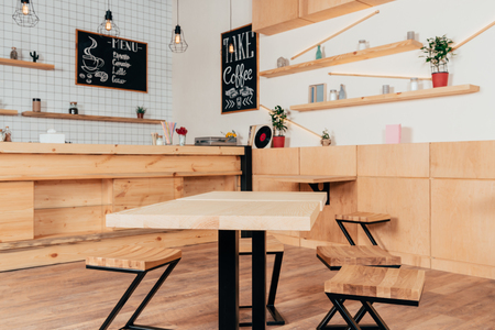 stylish interior of modern cafe with stylish wooden furniture