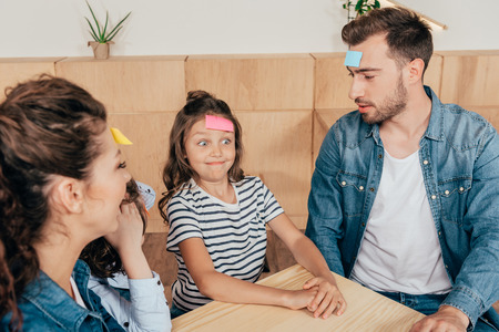 happy young family playing guess stickerの写真素材