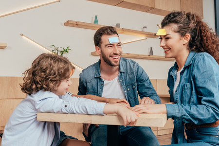 happy young family playing guess stickerの写真素材