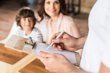 smiling mother and son making order in cafeの写真素材