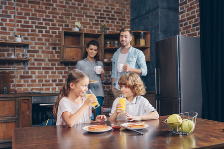 young happy family having breakfastの写真素材