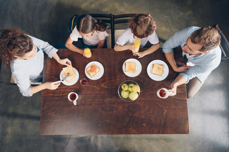 top view of young happy family having breakfastの写真素材