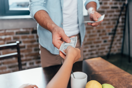 cropped shot of dad giving pocket money to daughterの写真素材
