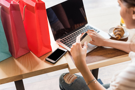 young woman making e-shopping in cafeの写真素材