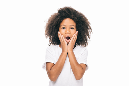 portrait of shocked african american girl looking at camera isolated on whiteの写真素材