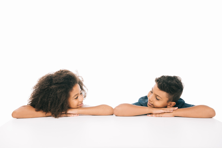 beautiful african american brother and sister smiling each other isolated on whiteの写真素材
