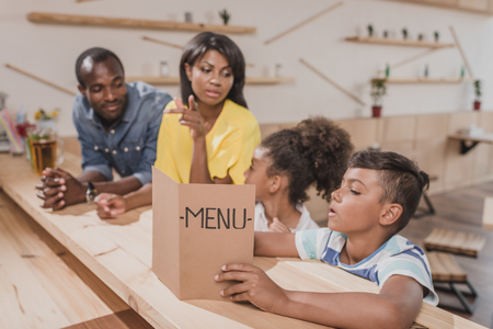 african-american family in cafe at bar counterの写真素材