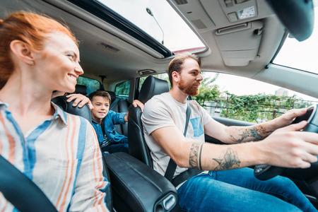 young happy family riding on car togetherの写真素材