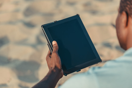 cropped shot of african american man using digital tablet with blank screen の写真素材