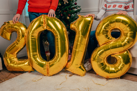 couple with new year balloons in shape of numbersの写真素材