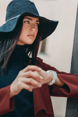 young stylish woman in black hat with stylish watchの写真素材