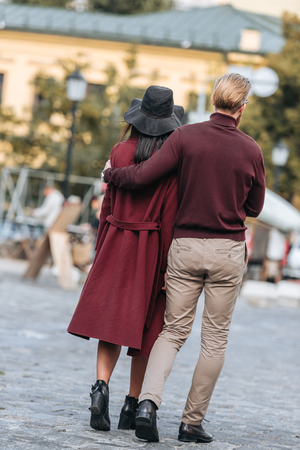 back view of young couple walking at old european cityの写真素材