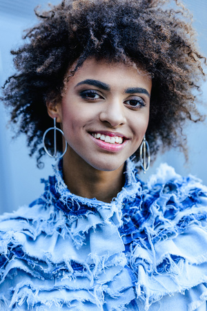 portrait of smiling african american girl in denim clothes posing for fashion shootの写真素材