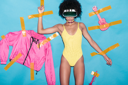 fashionable african american girl in yellow bodysuit, pink bomber and musical toys glued with scotch...