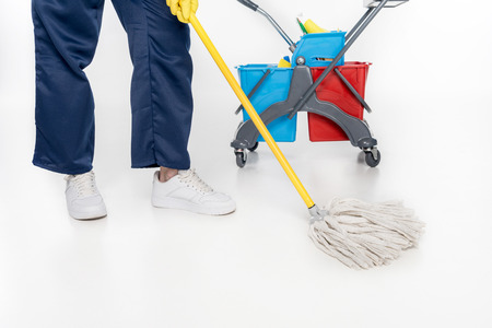 partial view of cleaner mopping floor with mop isolated on white