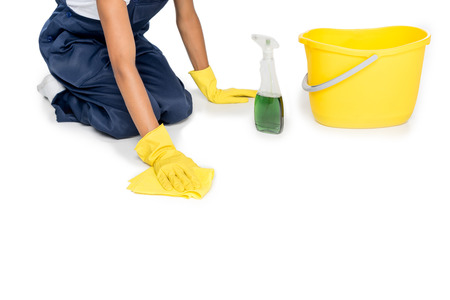 cropped shot of cleaner in rubber gloves tidying floor with duster isolated on white