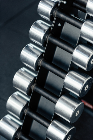 close up of row of dumbbells in sport center