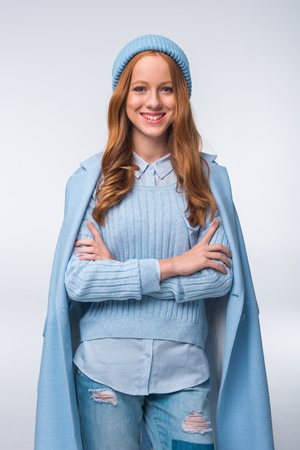 beautiful redhead elegant girl in blue autumn outfit, isolated on greyの写真素材