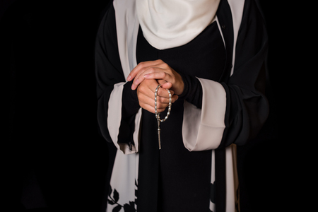 cropped shot of muslim woman with prayer beadsの写真素材