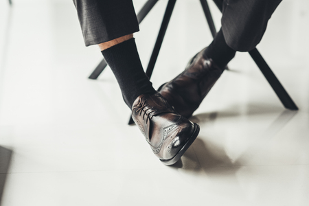 cropped shot of businessman in stylish leather shoesの写真素材