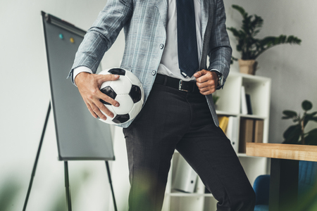 cropped shot of businessman with soccer ball at workplaceの写真素材