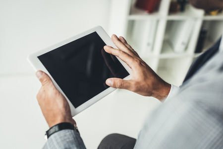 cropped shot of businessman using digital tablet の写真素材