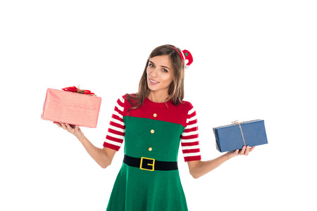 portrait of young woman in elf costume with presents in hands looking at camera isolated on whiteの写真素材