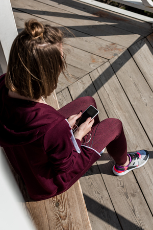 high angle view of woman using smartphone outdoorsの写真素材