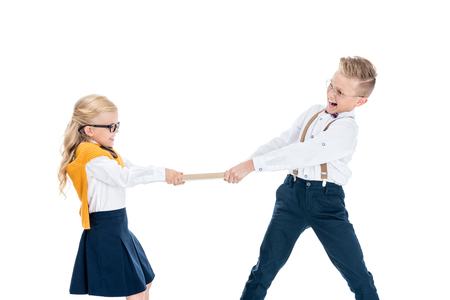 cute boy and girl fighting for book isolated on whiteの写真素材