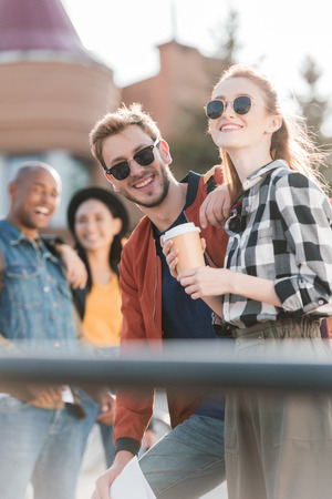 selective focus of happy multicultural friends on streetの写真素材