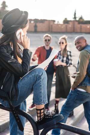 selective focus of asian woman with map in hand talking on smartphoneの写真素材