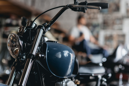 close up view of motorcycle standing in repair shopの写真素材