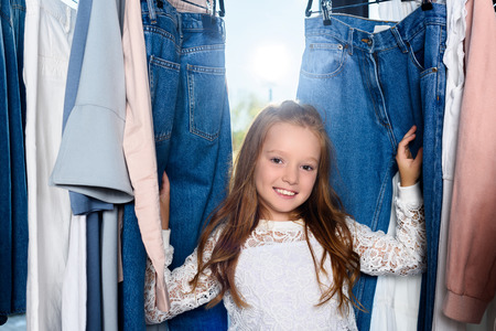 adorable smiling stylish child posing in boutique  の写真素材