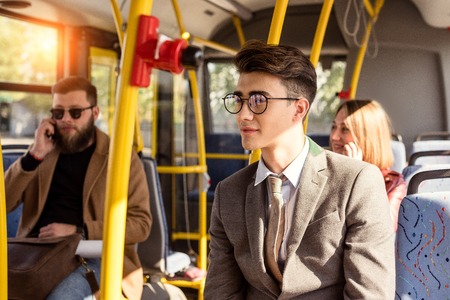 selective focus of pensive man in eyeglasses riding in busの写真素材