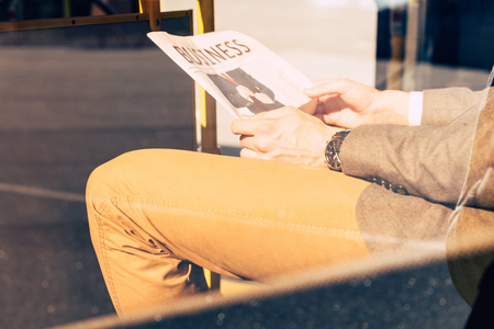 cropped shot of man with newspaper in city busの写真素材