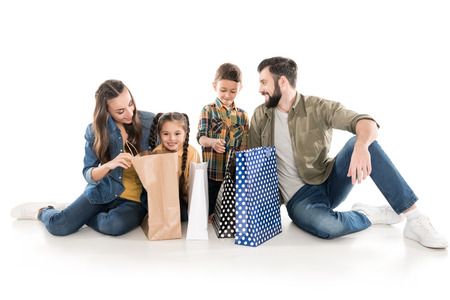 happy family with kids holding shopping bags, isolated on whiteの写真素材