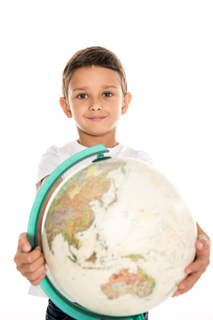 portrait of smiling little boy with globe in hands looking at camera isolated on whiteの写真素材