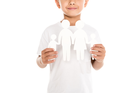 cropped shot of smiling boy with family paper model isolated on whiteの写真素材