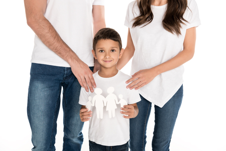 partial view of smiling little boy with family model in hands and parents near by isolated on whiteの写真素材