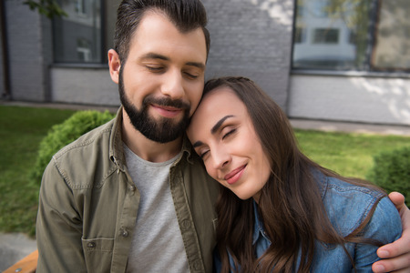 tender couple hugging with closed eyesの写真素材