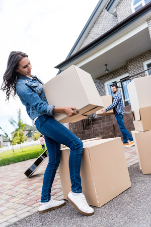 young couple with boxes moving into new houseの写真素材